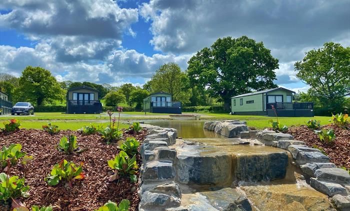Caravans wrapped around two pools and waterfall